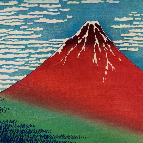 A nineteenth century engraving by Japanese Katsushika Hokusai which shows a red mountain and a blue sky with clouds.