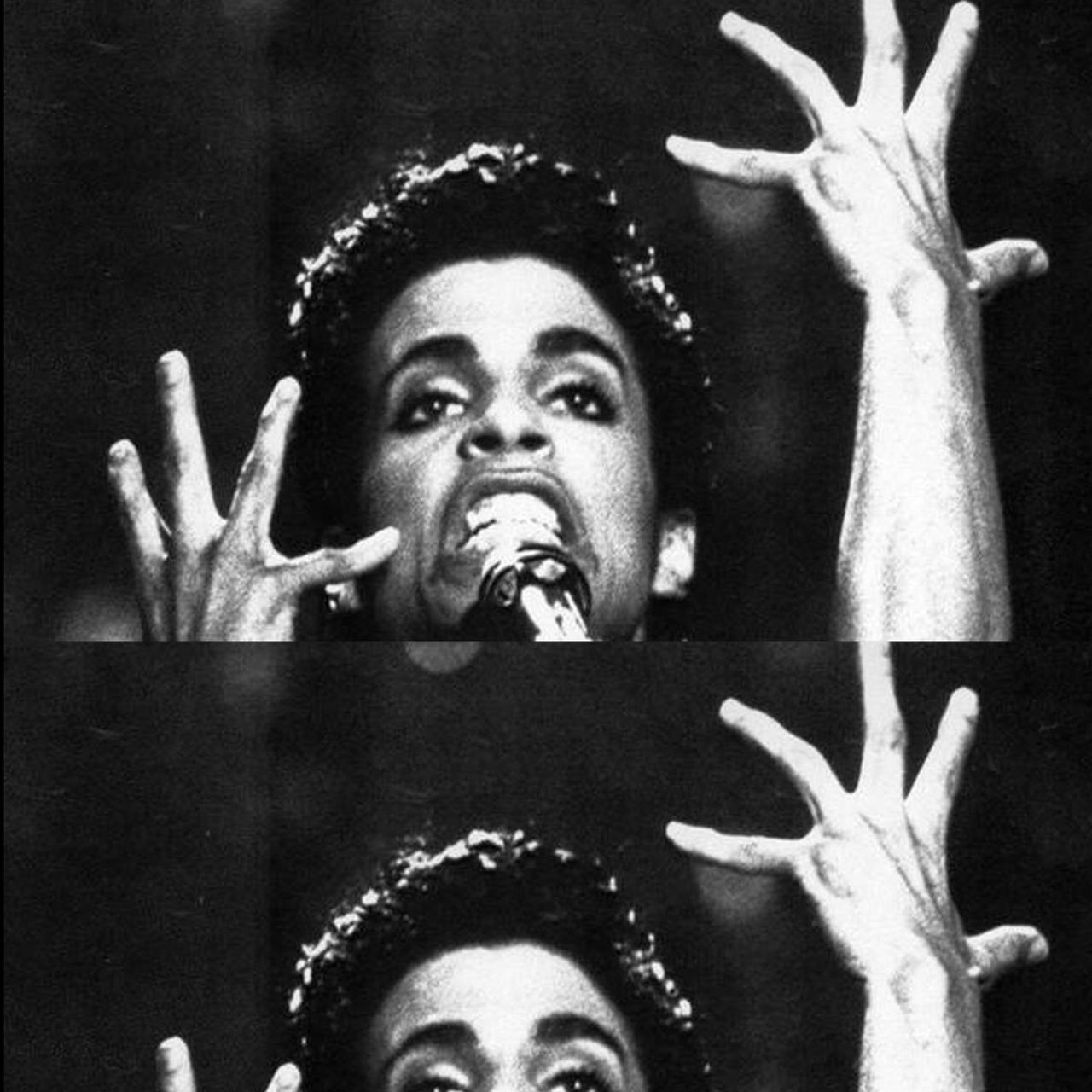 A photograph of Prince during a performance, close-up with his eyes and hands raised towards the sky.