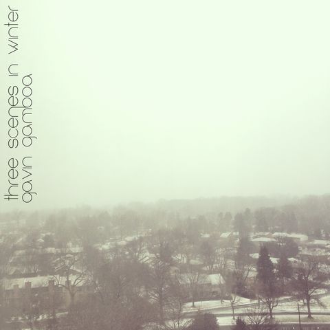 A photograph from a tall building looking down over a suburb in winter. The sky is overcast and the ground is covered in snow. The photograph is taken from a high angle, and the buildings are small and distant.